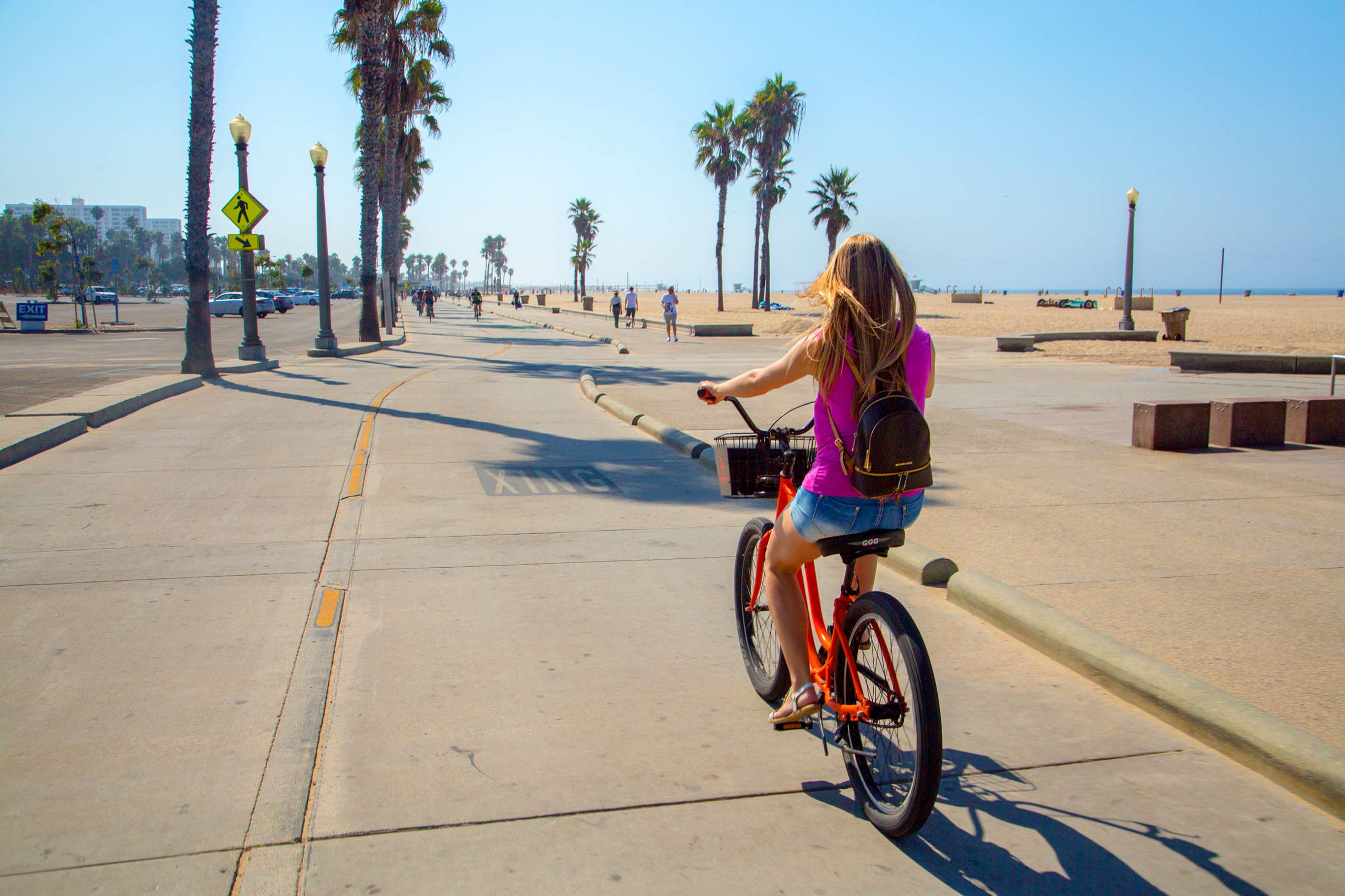 Woman riding bike at the beach